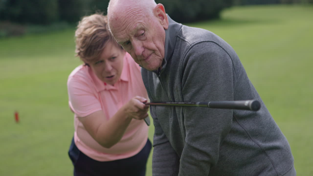 Senior golfer receiving golf lesson