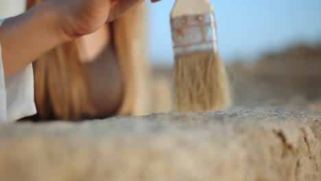 archaeologist cleaning an artifact