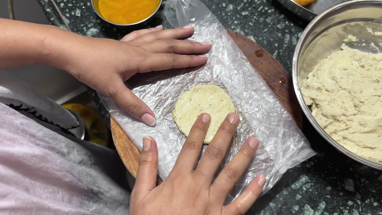 Vada making, Indian women making lentil fritters also called dal vada at home
