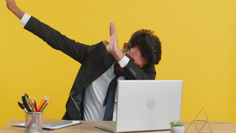 Business man having fun dancing and moving to rhythm dabbing raising hands making dub dance gesture