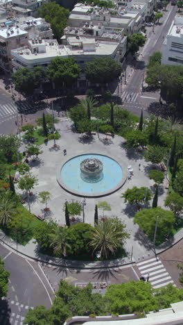 Circling around Dizengoff Square, Tel Aviv, hot summer day, quiet, people indoors - Vertical video