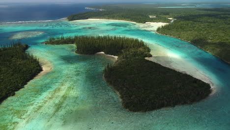 orbiting the small island of ile mwareya in oro's bay in the isle of pines - aerial parallax view