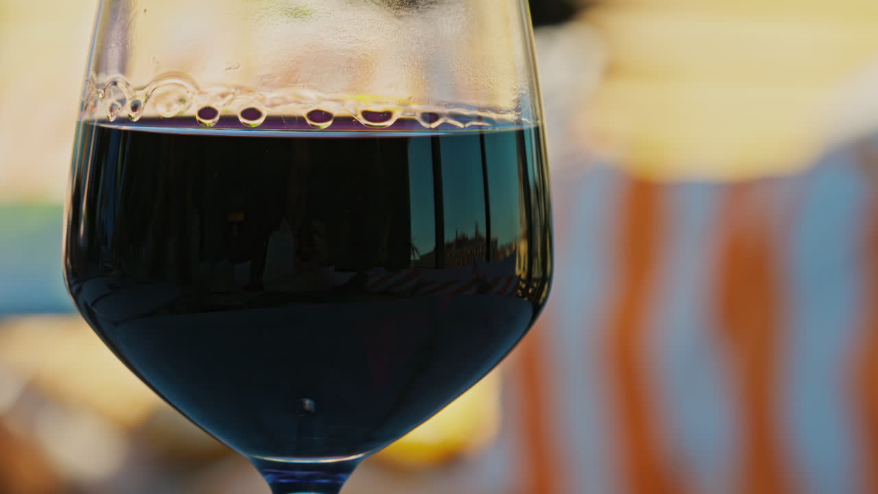 Close up of a glass of red wine on a table at a terrace