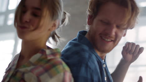 young family having fun during home repair. couple dancing in new house.