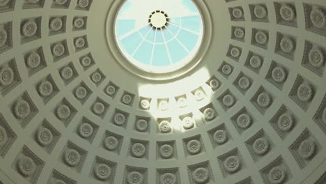 pan shot of a round dome, sun shines through a small window on the ceiling, and illuminates an old architecture, in the sun, at grabkapelle stuttgart, baden württenberg, in germany