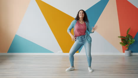 happy woman dancing in a colorful room