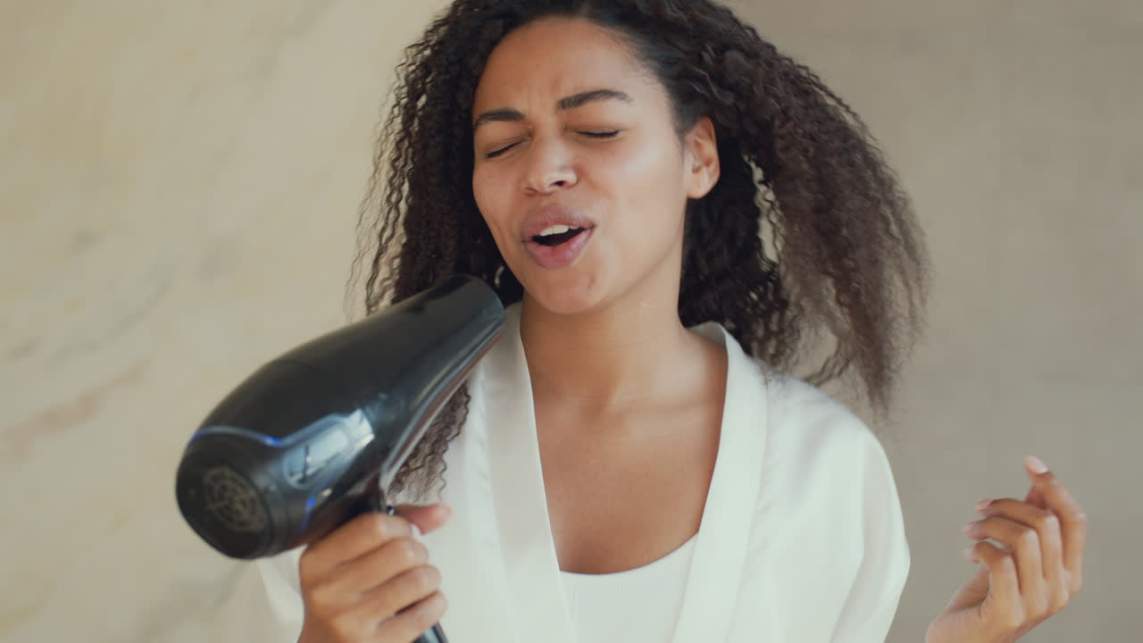 Woman Singing While Drying Her Curly Hair