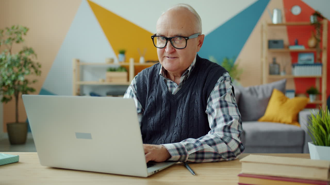 Senior Man Working on Laptop at Home