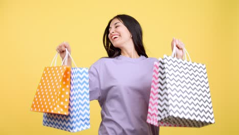 happy woman showing off shopping bags