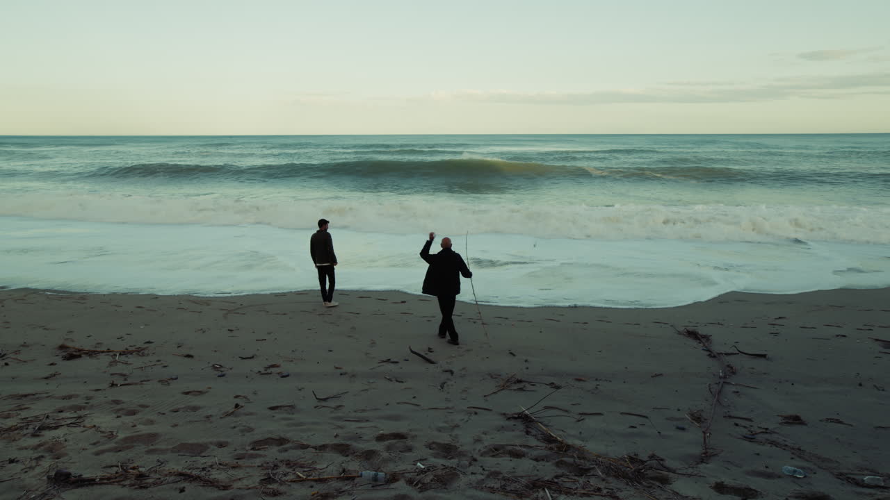 Silhouette Of Two People Admiring The Power Of Nature Stormy Ocean Waves