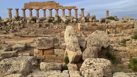 tilt-down from greek temple to ancient sundial engraved in rock at selinunte archaeological park in sicily, italy