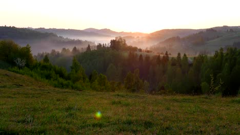 beautiful view in transylvania, from high mountain fields with flowers, hey stacks in front, a slow lateral dolly motion