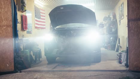 review of a car that shines with bright headlights from the workshop garage and a light haze covers the light from the headlights