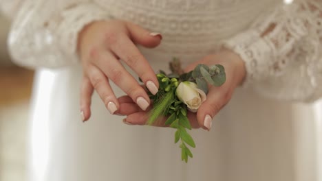 bride holding a wedding boutonniere