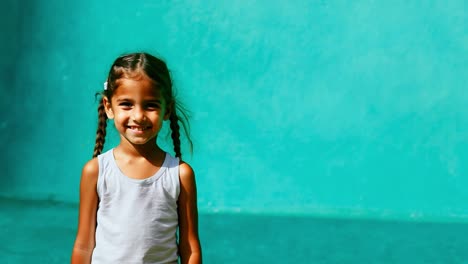 portrait of a young girl with braids, each picture showing her smiling