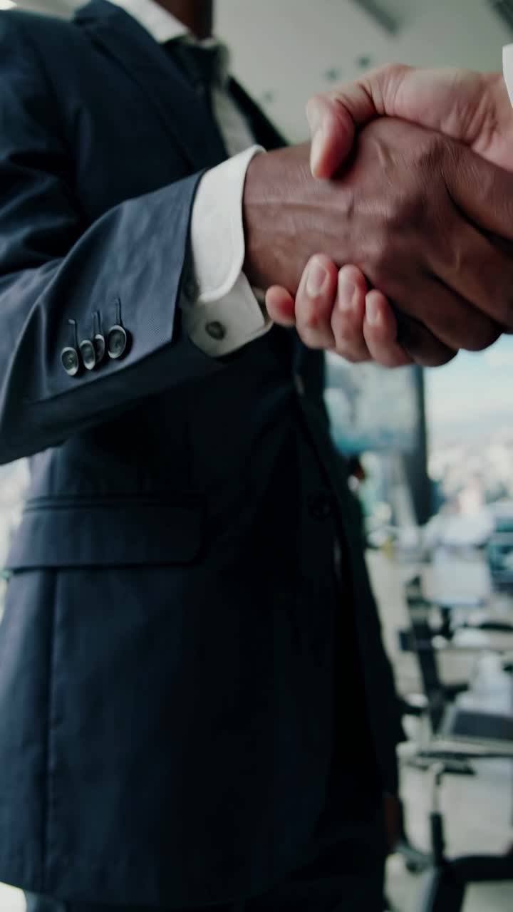 Two Businessmen Shaking Hands in a Modern Office