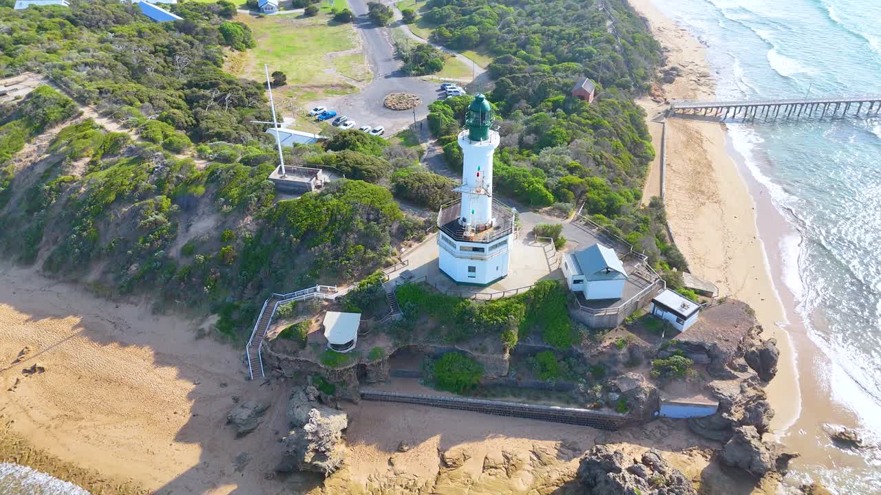 Aerial footage of Point Lonsdale Lighthouse, capturing the coastal landscape and ocean in bright daylight