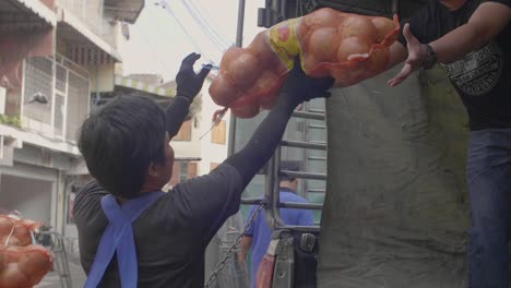 men loading onions on to truck