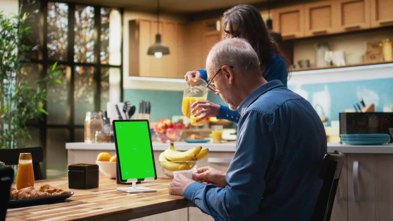 Vertical chroma key tablet with senior man enjoying morning routine