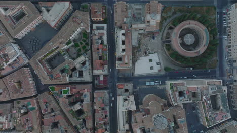 Birds-eye-shot-of-historic-buildings-and-sights-in-city-centre.-Fly-over-San-Carlo-al-Corso-and-Mausoleum-of-Augustus.-Rome,-Italy