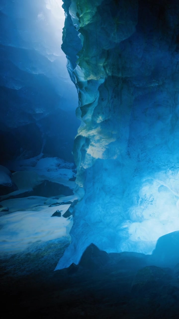 Exploring a cave with blue light and rock formations in the dark