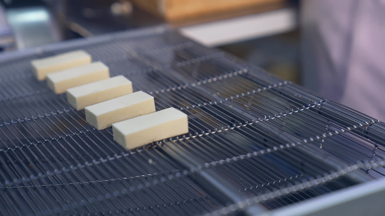 Delicious factory making deserts. Tasty sweet candies on conveyor.