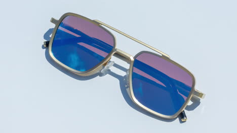 mirrored sunglasses reflecting clouds