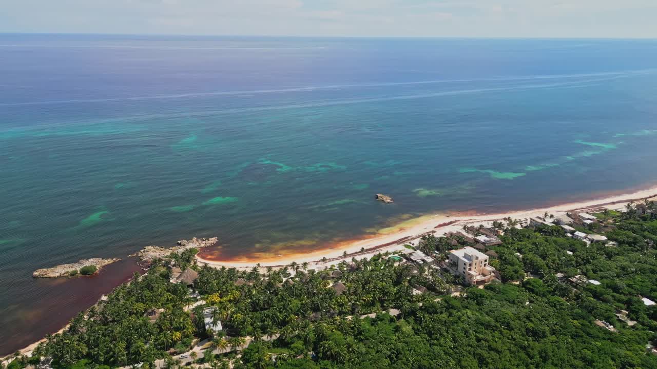 Aerial view of Tulum beach, capturing coastline and lush greenery