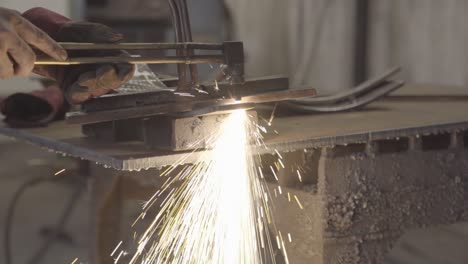 amazing spark shower while cutting a thick steel plate with handheld plasma cutter