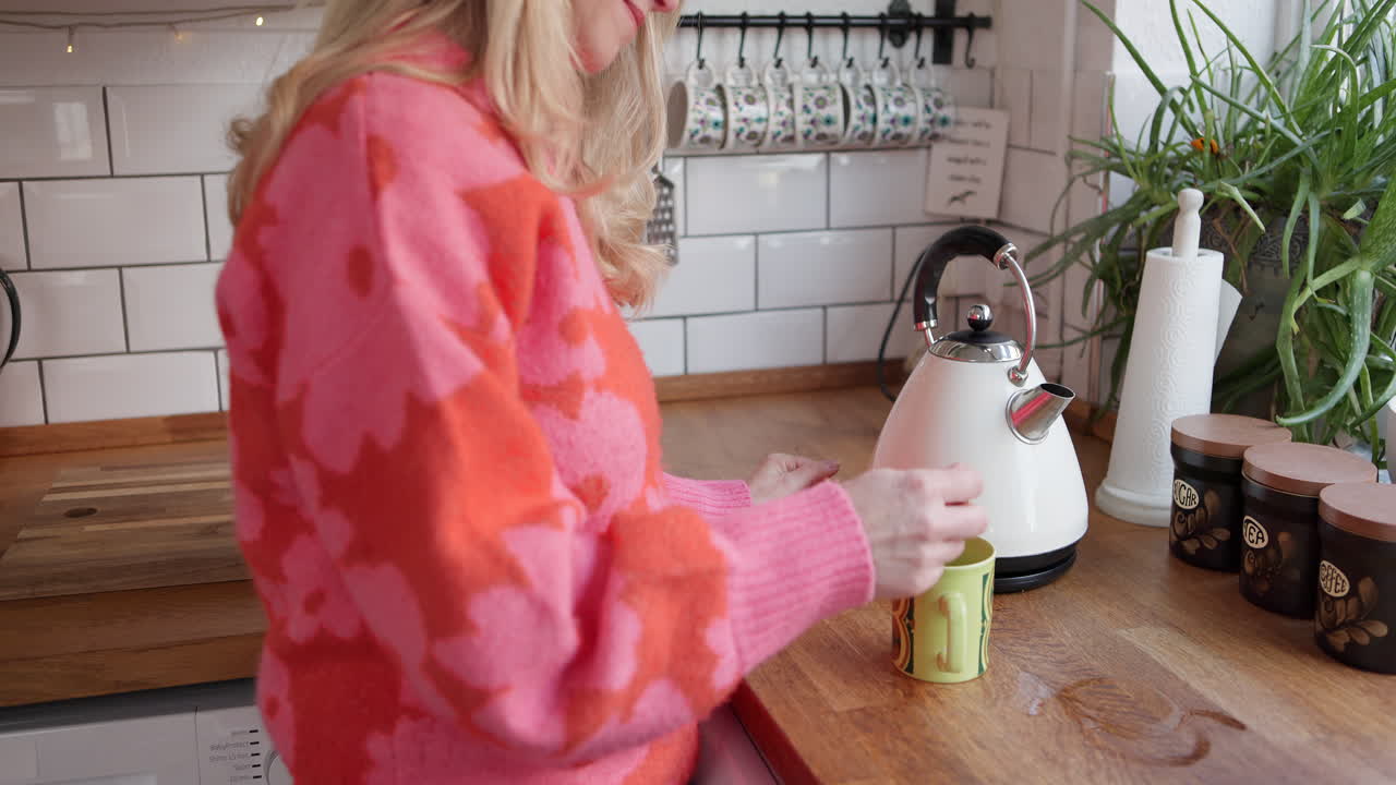Woman drinking tea in the kitchen