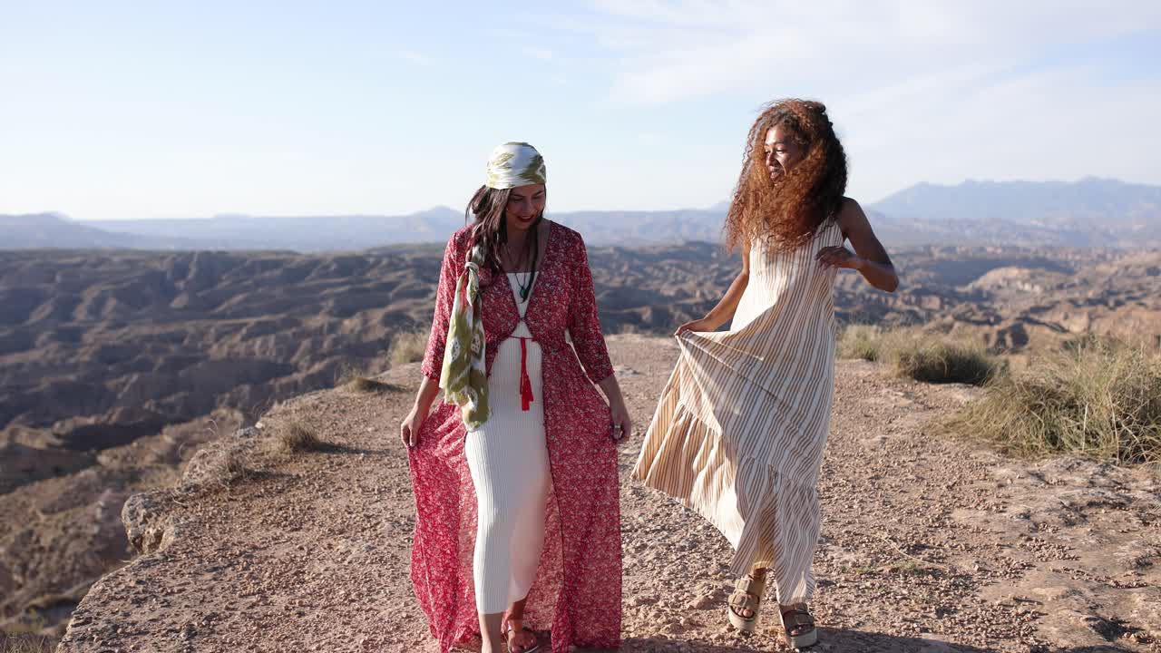 Two women walking on a scenic desert path