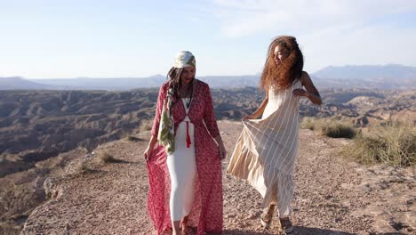 two women walking on a scenic desert path