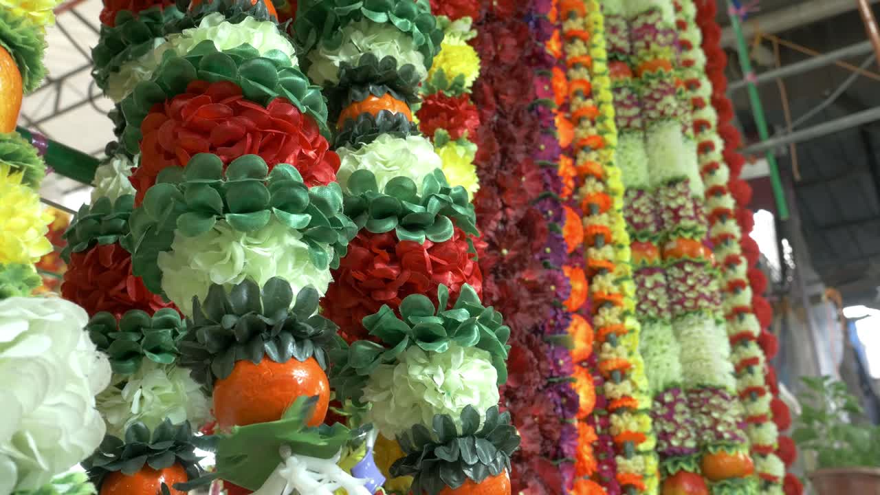Vibrant flower garlands hanging in a market