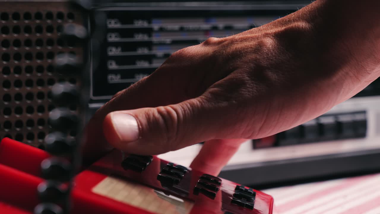 Retro vintage red phone, telephone is displayed on a wooden desk, adding a nostalgic touch. Man answer for call on button 90 phone.