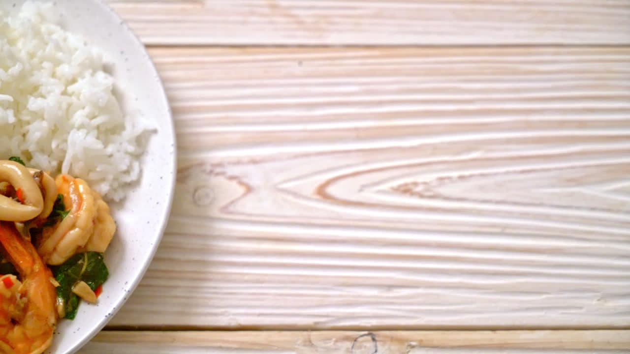 rice and stir-fried seafood (shrimps and squid) with Thai basil - Asian food style