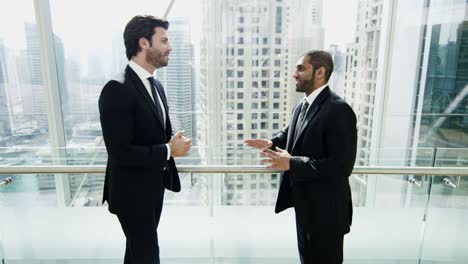 male middle eastern caucasian businessmen meeting downtown office