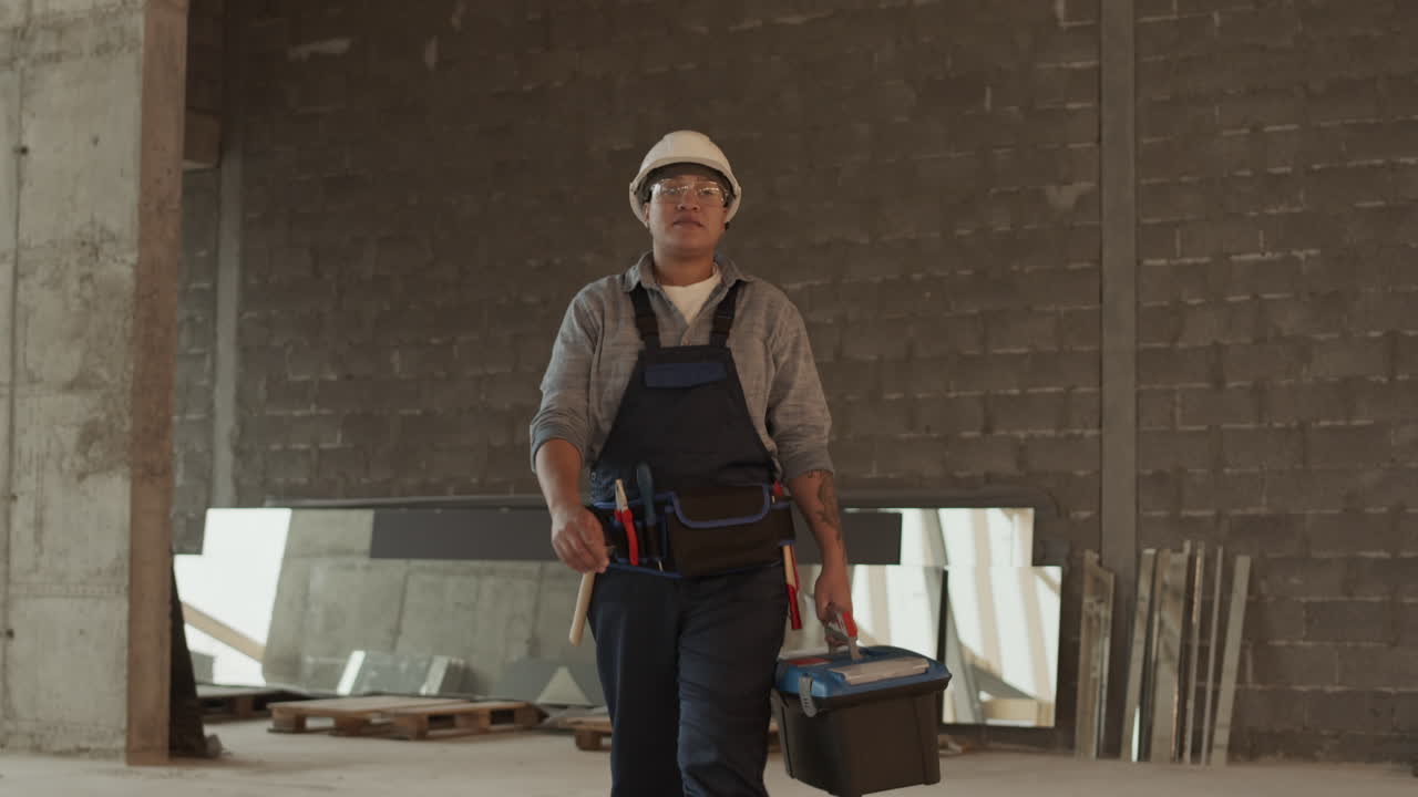 Construction Worker Walking with Toolbox