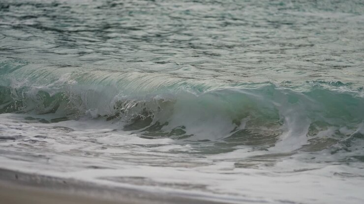 Powerful waves are spilling on the sandy beach