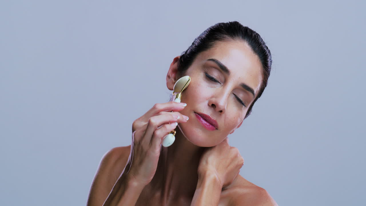 Woman Using a Face Roller for Skin Care