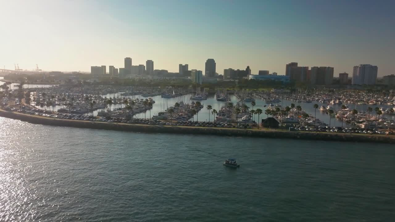 Aerial descending shot towards yacht and sailboat marina. 4K