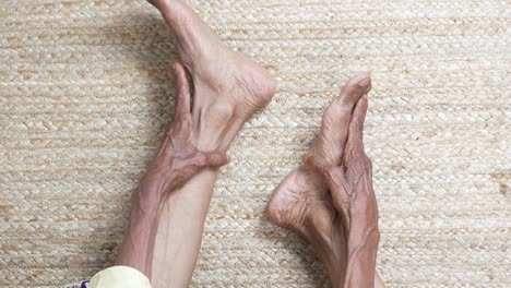 close up on senior women feet and hand massage on injury spot