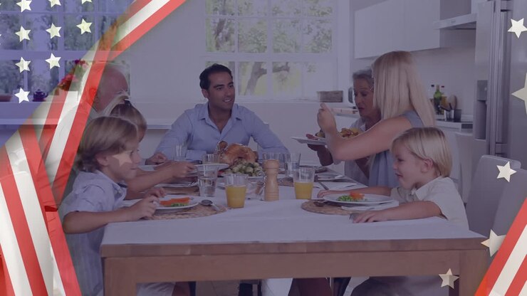 Animation of U.S. flag and white stars over multi-generation Caucasian family eating breakfast
