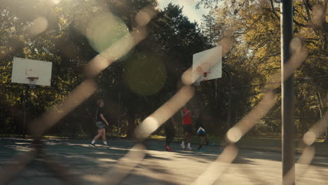 friends playing basketball outdoors