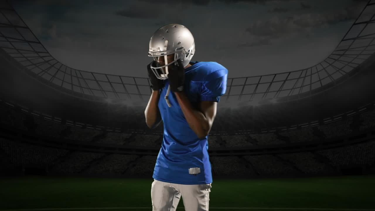 Professional American football player standing in front of a sports stadium