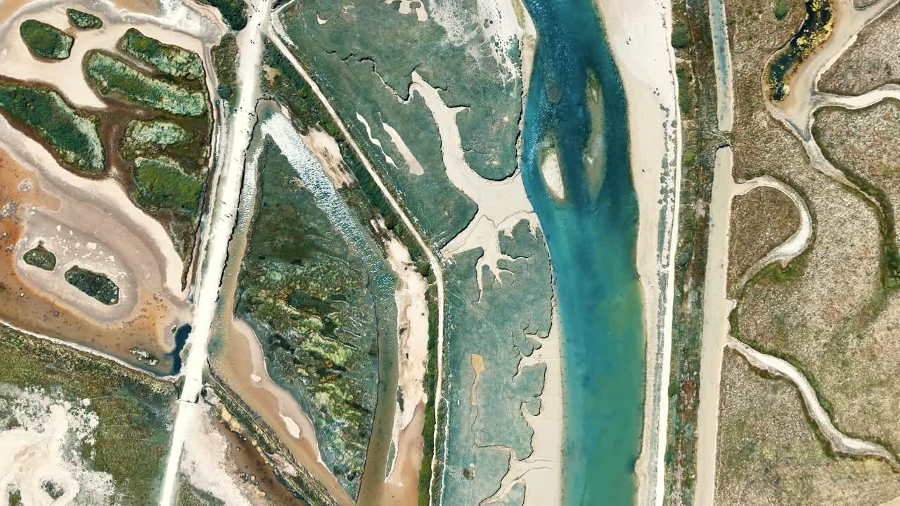 Cinematic drone footage over Cuckmere Haven, where the winding River Cuckmere meets the sea beside the Seven Sisters cliffs. Oxbow lakes, floodplains, and breathtaking coastal views