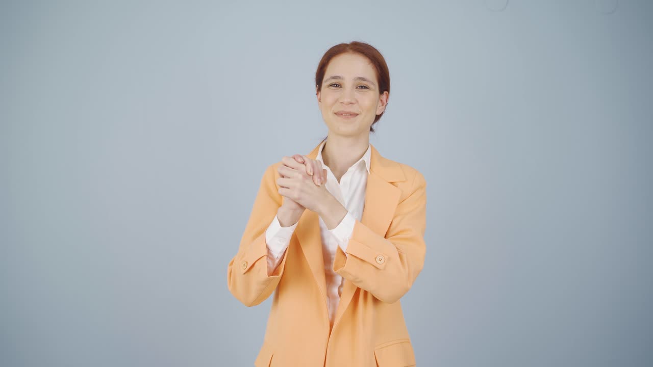 Business woman making a trust sign at the camera.