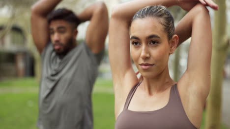 Fitness,-couple-or-friends-stretching-arm-in-park