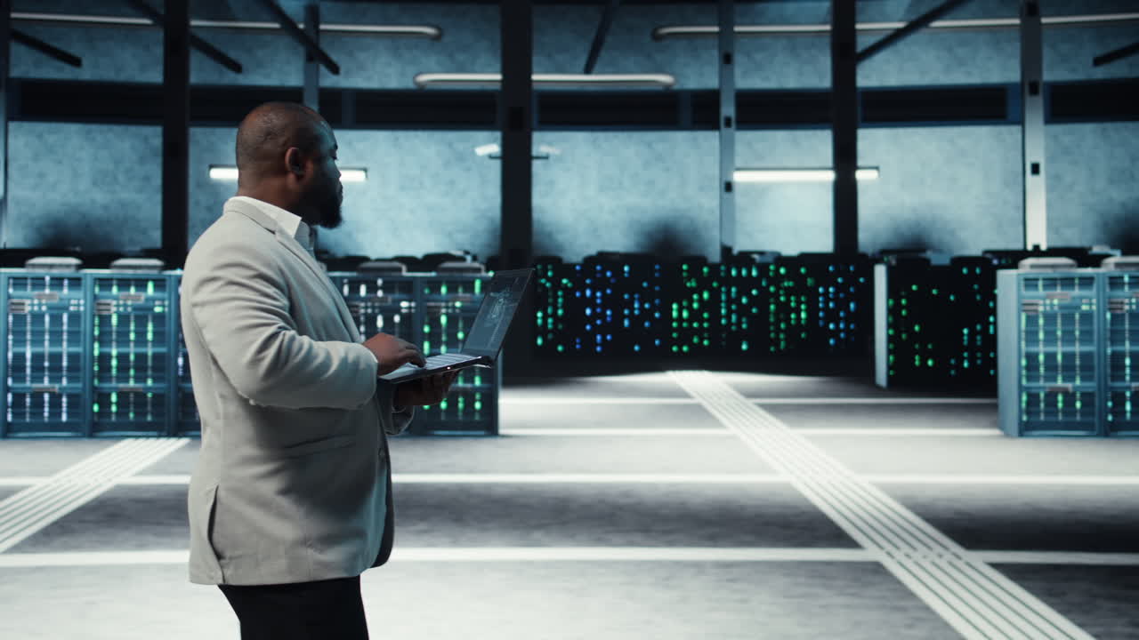 Vertical video Server room system administrator using laptop to do AI automatization