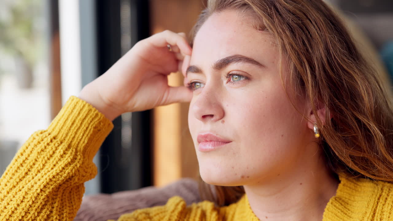 Portrait of a pensive woman in yellow sweater