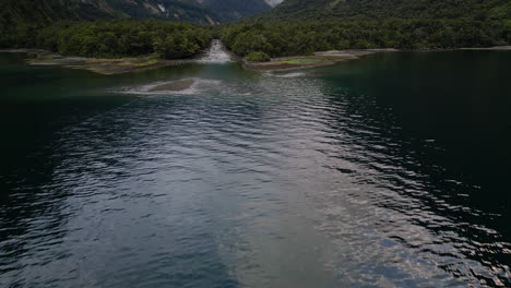 Harrison-River-Flowing-To-Milford-Sound-With-Tree-Avalanche-On-Mount-Pembroke-In-The-Background-In-New-Zealand